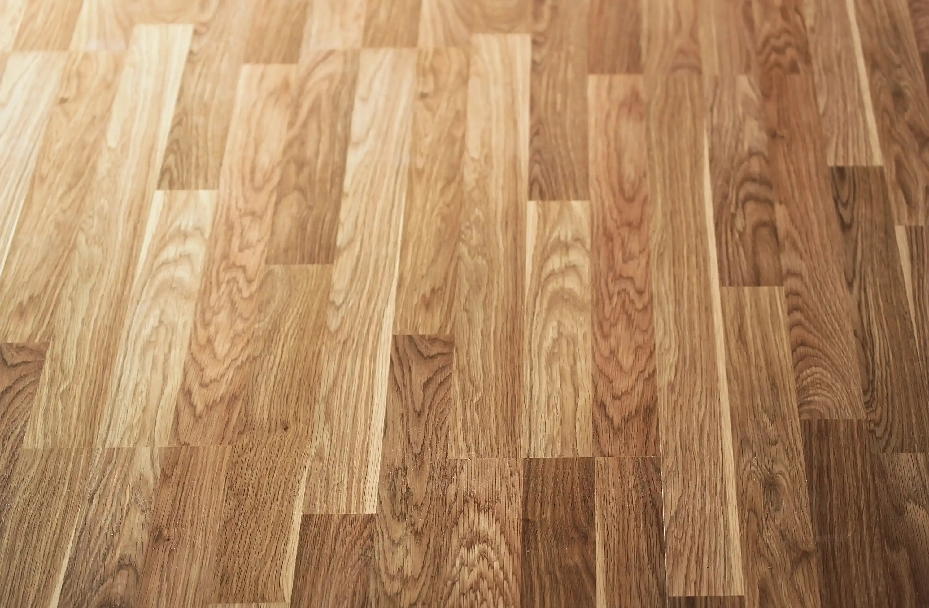 Close view of wood-look laminate planks showing grain, texture, and color variation from board to board