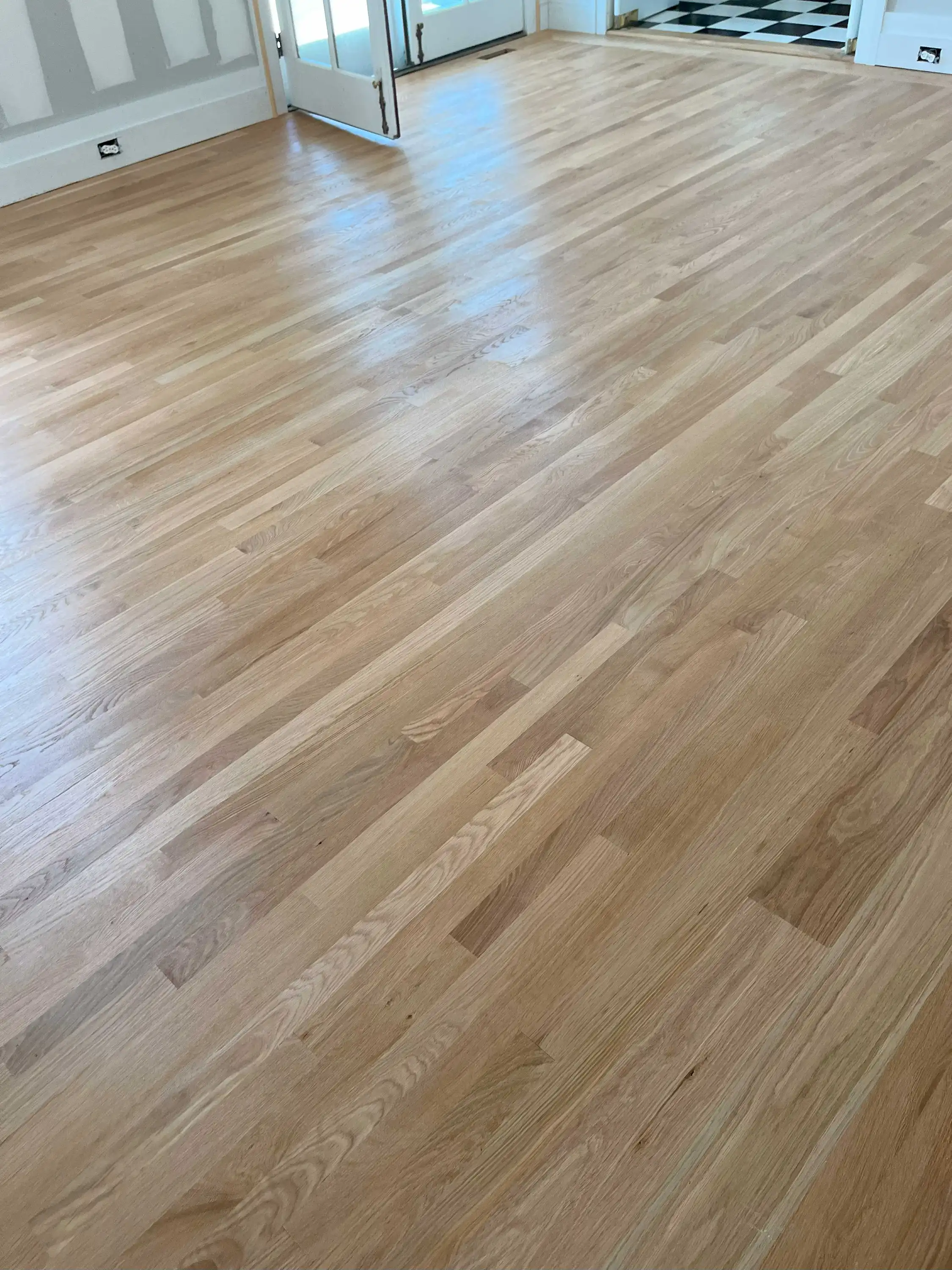 A refinished mid-brown oak floor in a furnished family room